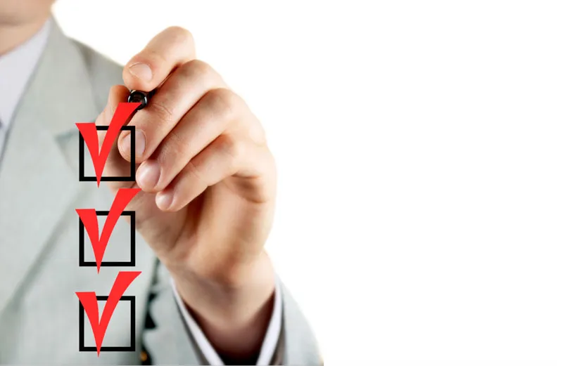 Business-man-checking-boxes-with-red-pen